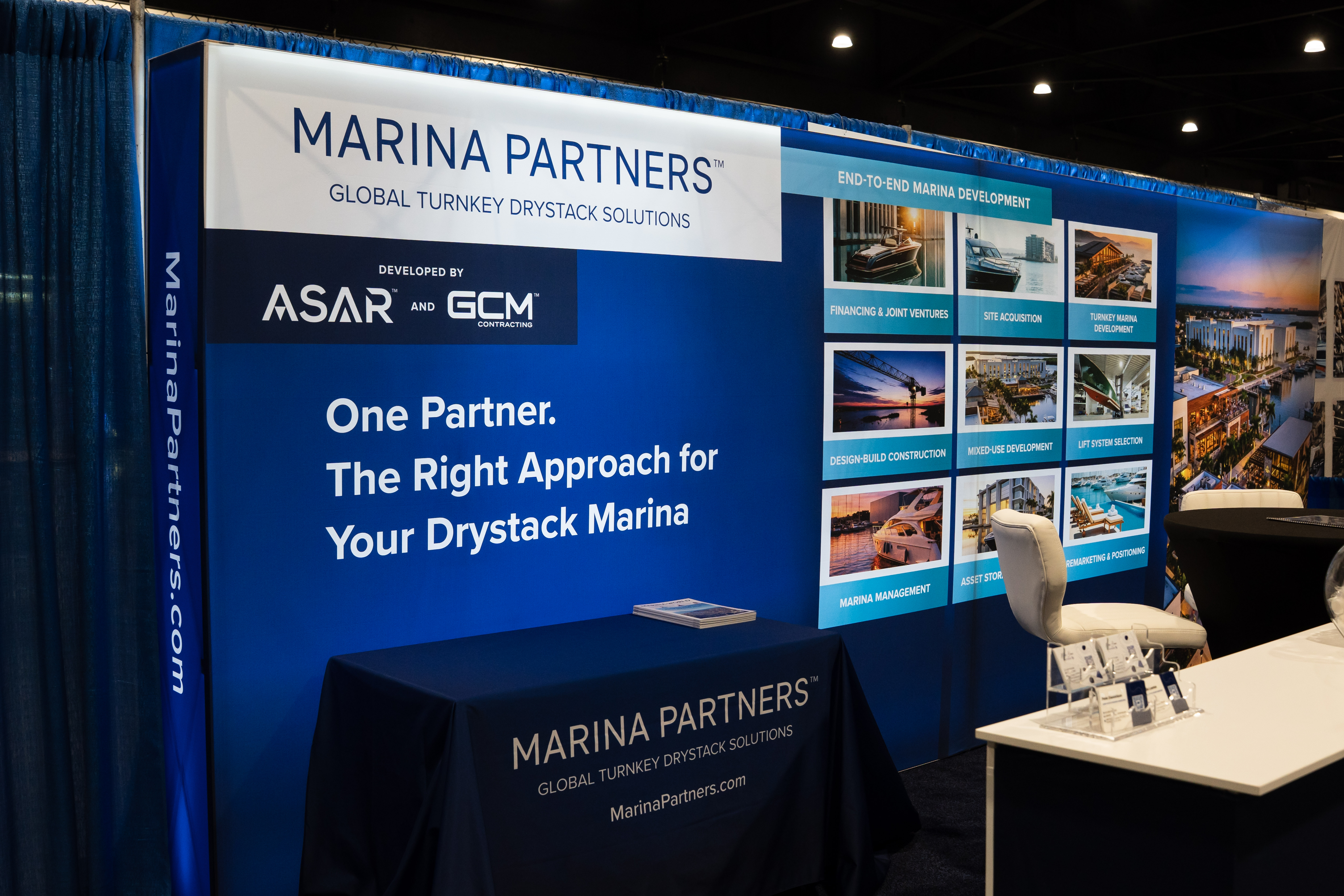 Marina partners networking at the trade show, discussing collaboration and industry trends in a professional setting.